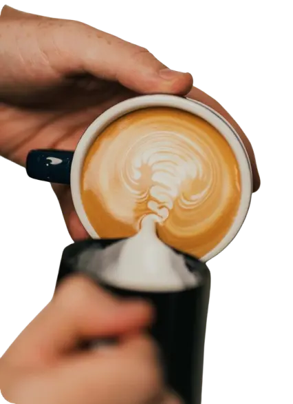 Milk swirling into iced coffee in glass